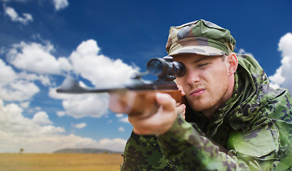 Image showing soldier or hunter with gun aiming or shooting