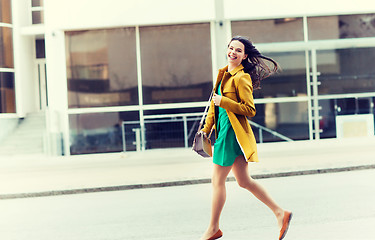 Image showing happy young woman or teenage girl on city street