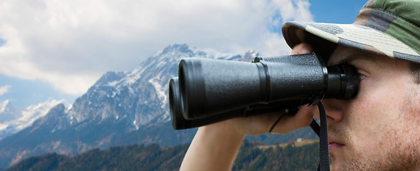 Image showing close up of soldier face looking to binocular