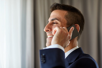 Image showing businessman calling on smartphone at hotel room