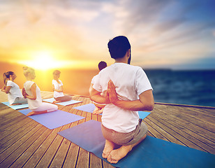 Image showing group of people doing yoga outdoors