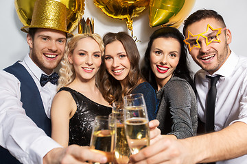 Image showing happy friends clinking champagne glasses at party