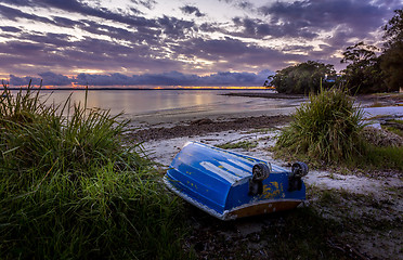 Image showing The little blue rowboat on the shore