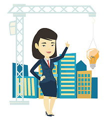 Image showing Woman pointing at idea bulb hanging on crane.