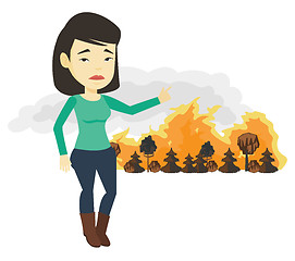Image showing Woman standing on the background of wildfire.