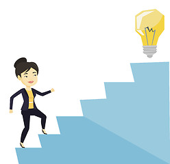 Image showing Business woman walking upstairs to the idea bulb.