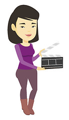 Image showing Smiling woman holding an open clapperboard.