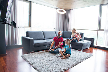 Image showing Happy family playing a video game