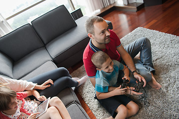 Image showing Happy family playing a video game