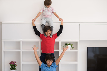 Image showing young boys posing line up piggyback