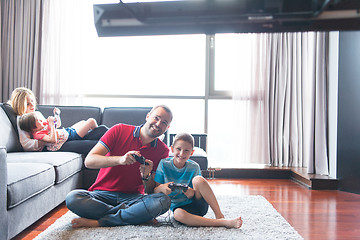 Image showing Happy family playing a video game