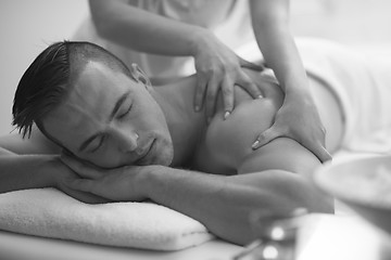 Image showing young man having a back massage