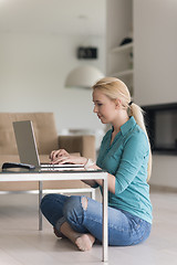 Image showing young women using laptop computer on the floor