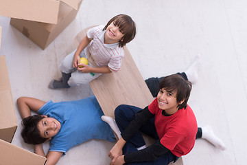 Image showing boys with cardboard boxes around them top view