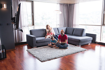 Image showing Happy family playing a video game