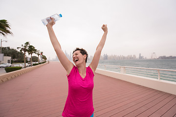 Image showing young woman celebrating a successful training run