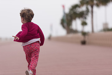 Image showing cute little girl on the promenade by the sea
