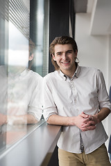 Image showing young businessman in startup office by the window