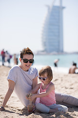 Image showing Mom and daughter on the beach