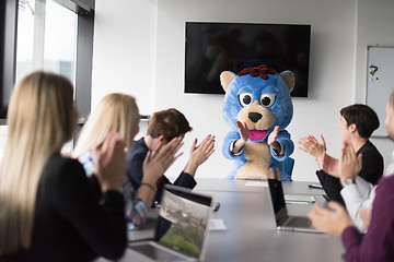 Image showing boss dresed as bear having fun with business people in trendy of