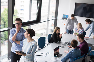 Image showing Two Business People Working With Tablet in office