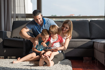 Image showing happy young couple spending time with kids