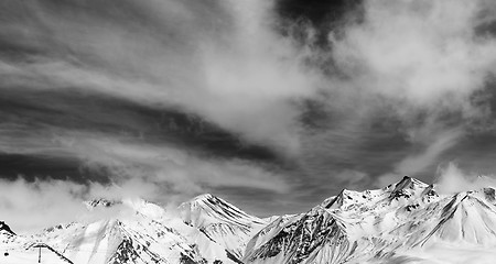 Image showing Black and white winter snowy mountains in fog