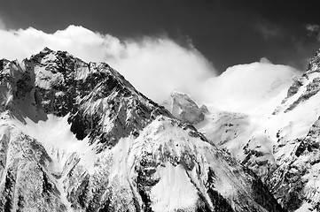 Image showing Black and white view of winter snow mountains in cloud