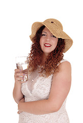 Image showing Woman with straw had and glass of water