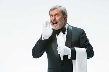 Image showing Senior waiter holding white towel