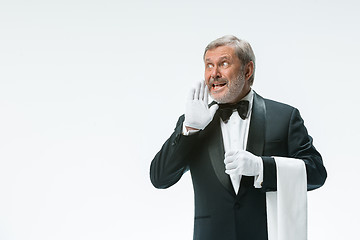 Image showing Senior waiter holding white towel