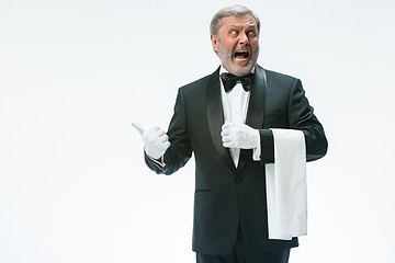 Image showing Senior waiter holding white towel