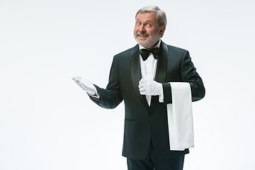 Image showing Senior waiter holding white towel