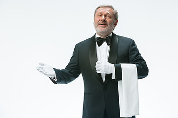 Image showing Senior waiter holding white towel