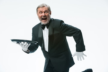 Image showing Senior waiter holding tray