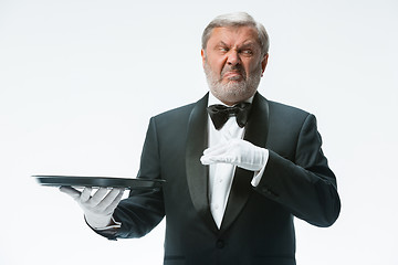 Image showing Senior waiter holding tray