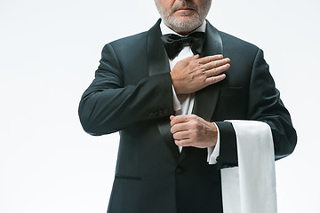 Image showing Senior waiter with white towel. Sign language in the restaurant