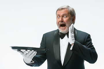 Image showing Senior waiter holding tray