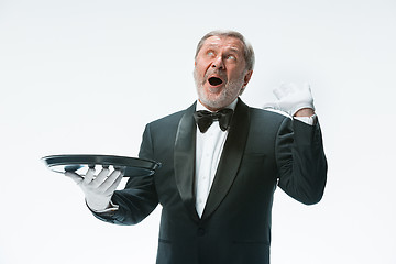 Image showing Senior waiter holding tray