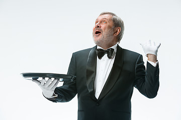 Image showing Senior waiter holding tray