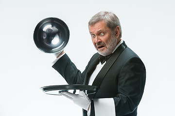 Image showing The waiter with tray and metal cloche lid cover