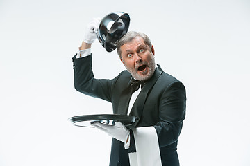 Image showing The waiter with tray and metal cloche lid cover