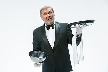 Image showing The waiter with tray and metal cloche lid cover