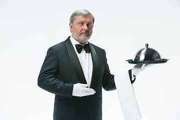 Image showing The waiter with tray and metal cloche lid cover