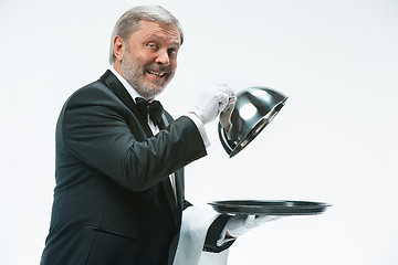 Image showing The waiter with tray and metal cloche lid cover