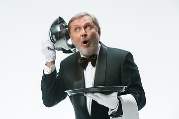 Image showing The waiter with tray and metal cloche lid cover