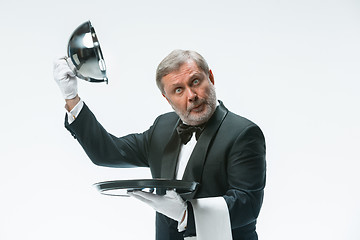 Image showing The waiter with tray and metal cloche lid cover