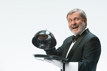 Image showing The waiter with tray and metal cloche lid cover