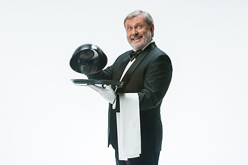 Image showing The waiter with tray and metal cloche lid cover