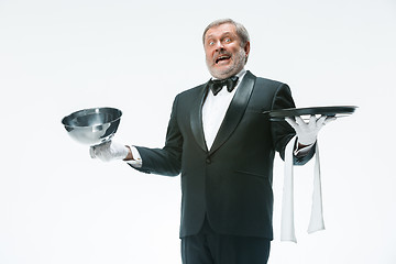 Image showing The waiter with tray and metal cloche lid cover